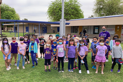 Young students wearing purple outside